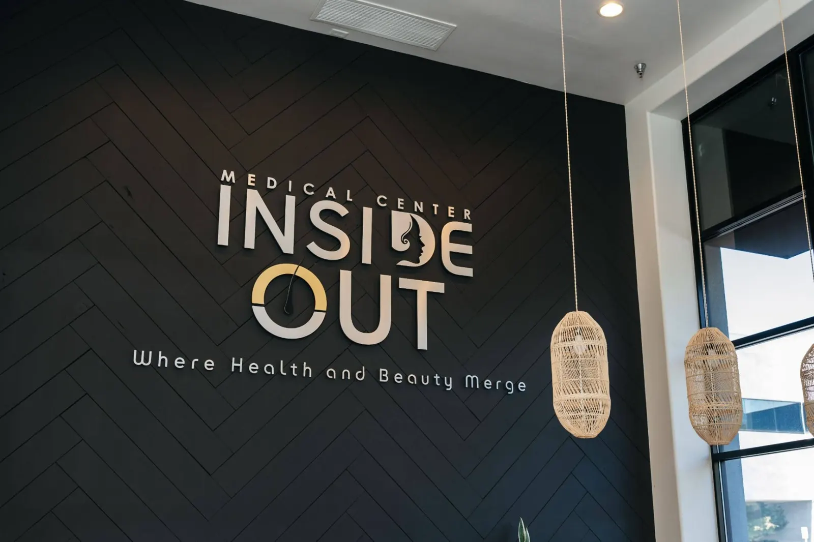 Inside Out Medical Center interior with decorative pendant lights and logo wall
